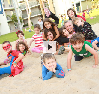 Family Vacation Center kids playing in a sandbox.